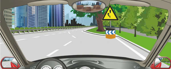 图中标志提醒障碍物在路中，车辆从右侧绕行。